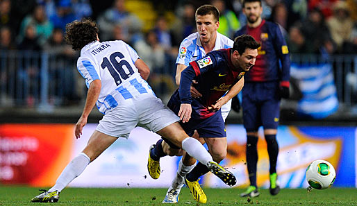 Lionel Messi (M.) traf per Kopf gegen Malaga zum 4:2-Endstand